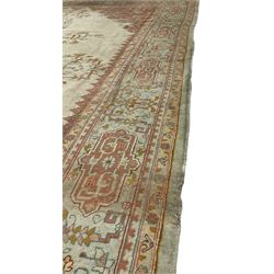 Large Persian pale sage ground carpet, the field decorated with central geometric medallion and tree of life motifs, the border with repeating geometric design decorated with stylised plant motifs