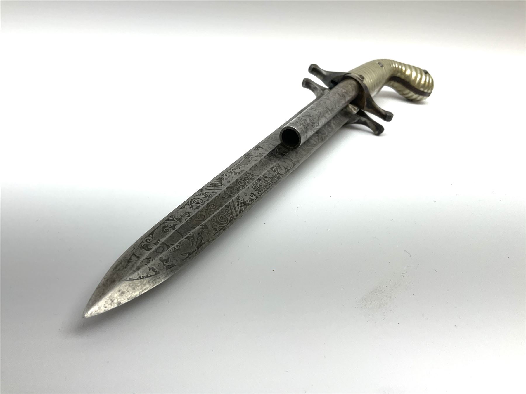 Rare double barrel percussion knife pistol by Dumonthier & Sons (NVN), approx. .38 calibre, with 8.5cm barrels and central 21.5cm spear pointed blade, all with etched damascening, upper quillons serve as hammers for the percussion ignition with single drop down trigger and fluted nickel grips, in nickel mounted leather covered tin scabbard L33.5cm overall