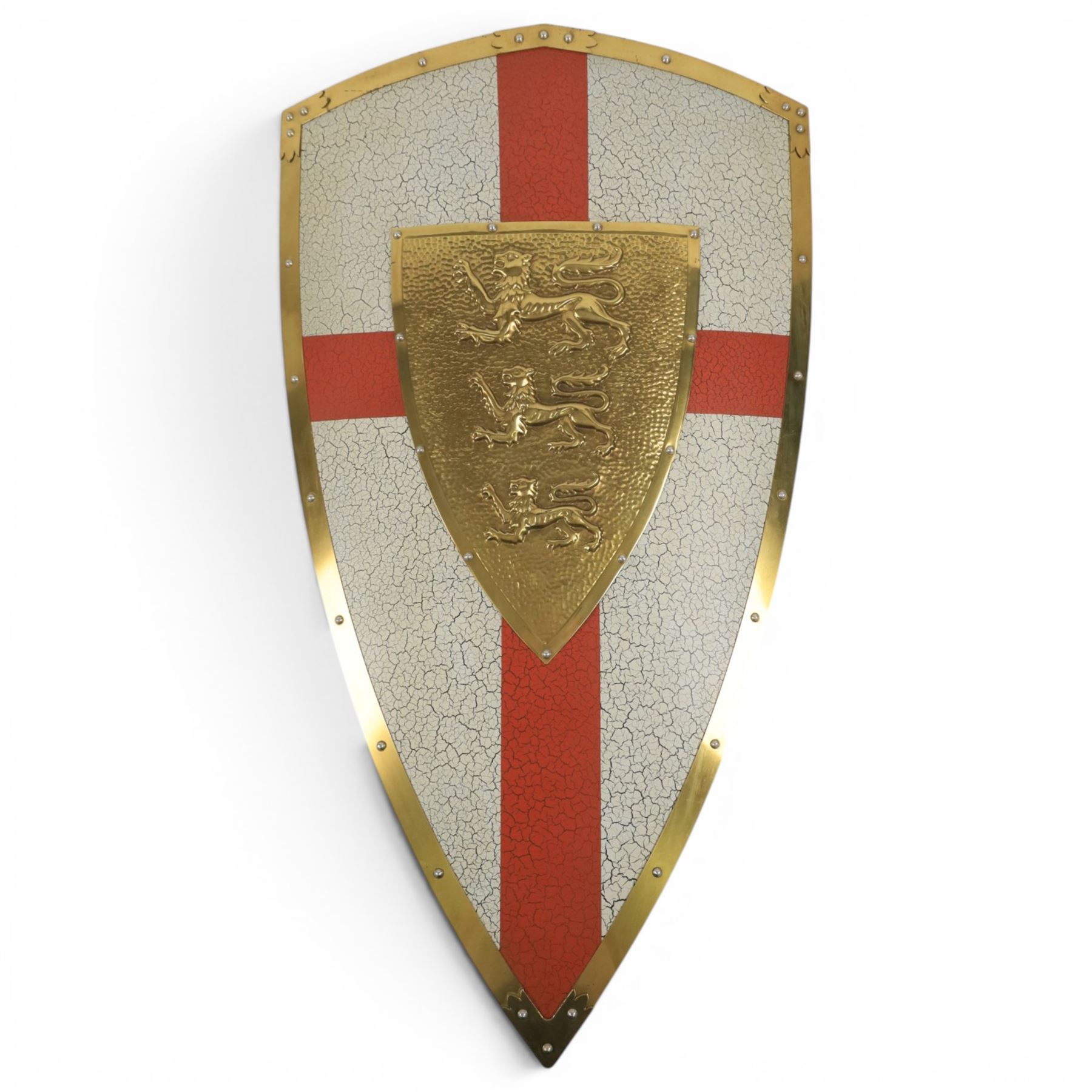 Five wall hangings, modelled as shields, decorated to the centre in relief with three lions 