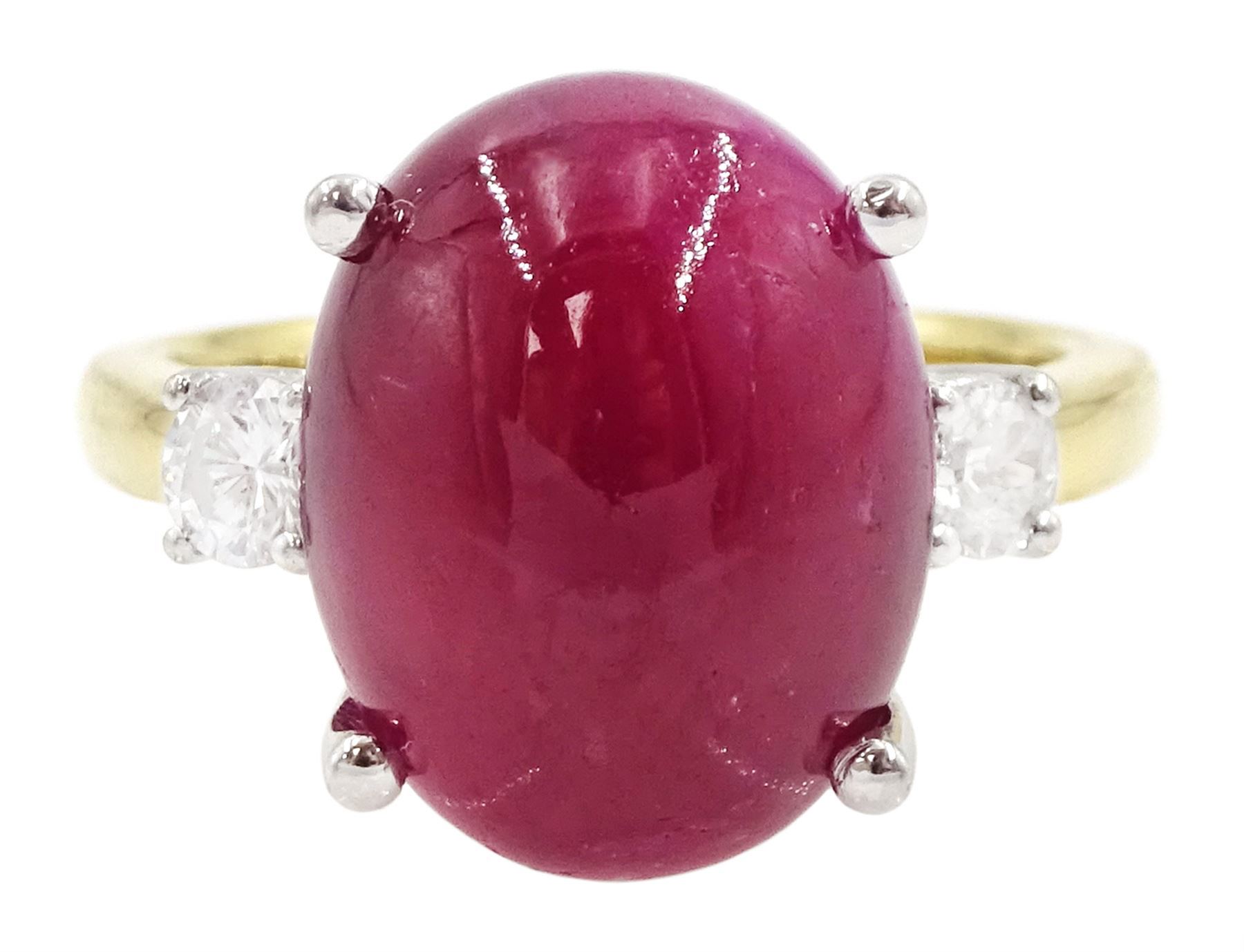 18ct gold ruby and diamond three stone ring, oval cabochon cut ruby of approx 11.40 carat, with a single round brilliant cut diamond set either side, hallmarked