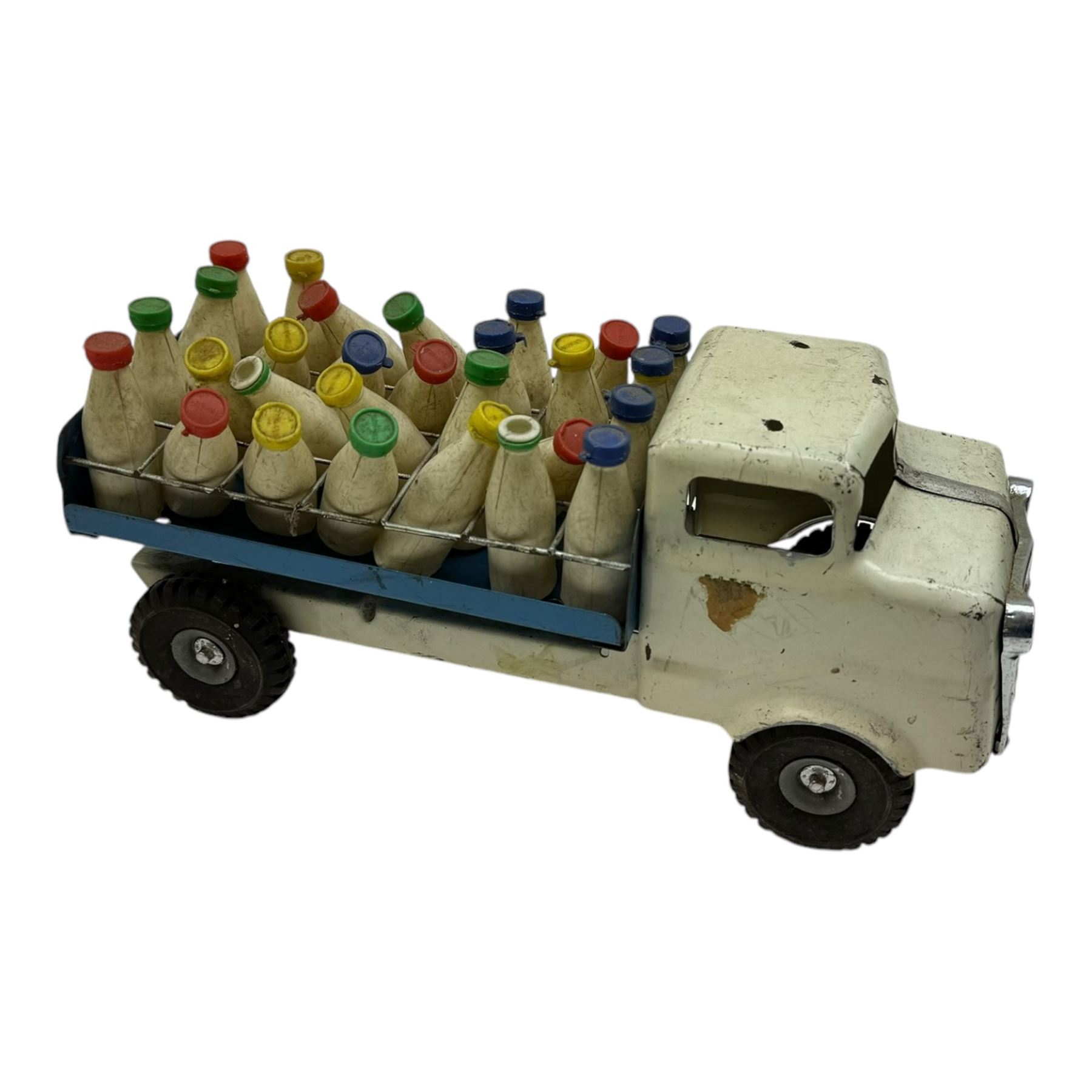 1950s Triang pressed steel milk float, containing twenty eight plastic milk bottles with coloured tops, together with a 1950s Triang pressed steel locomotive 'Triang Express', tallest H21cm