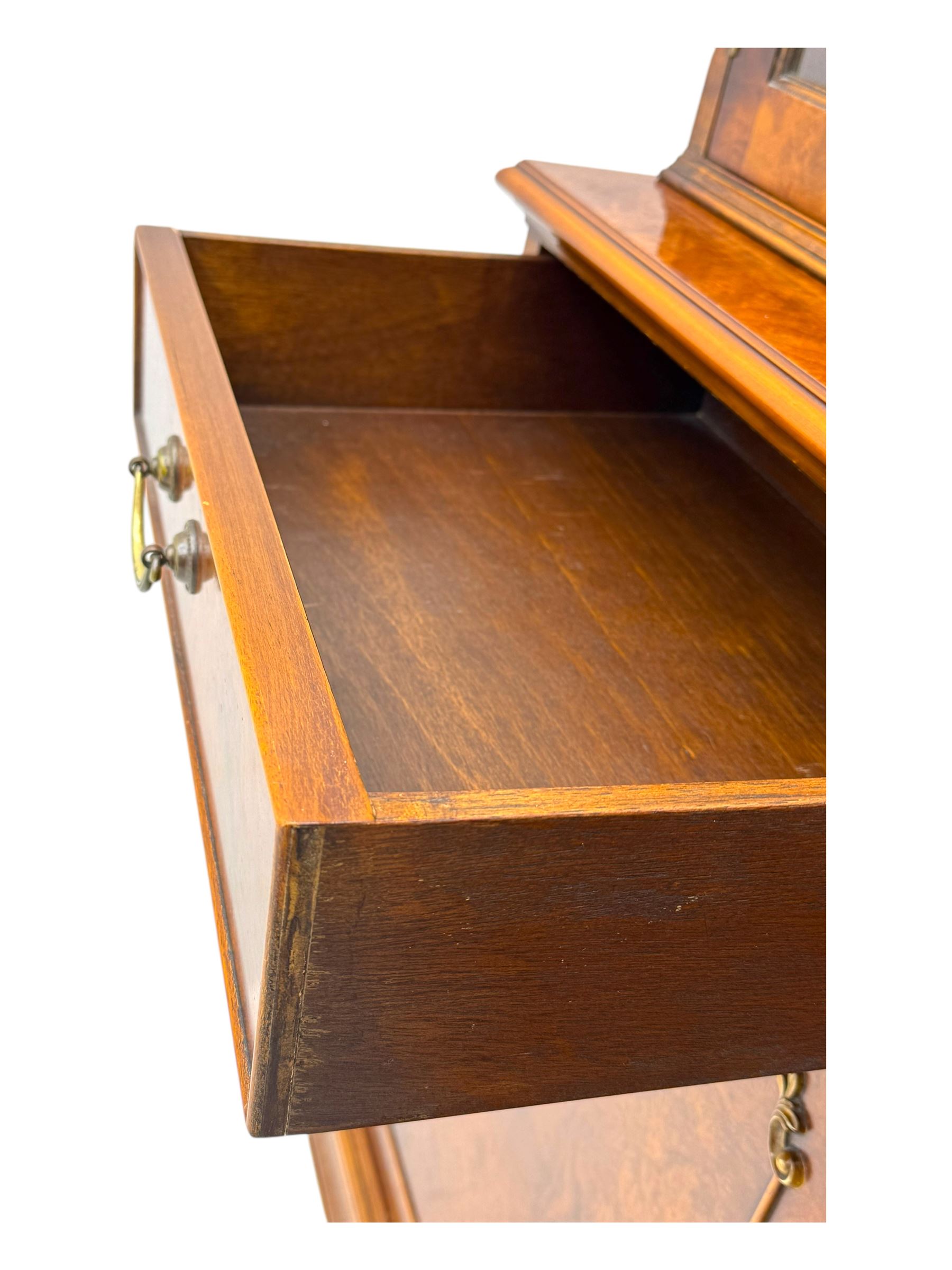 Ian Smith Furniture - Georgian design walnut bookcase on cupboard, projecting cornice above a pierced geometric frieze, featuring two astragal-glazed doors enclosing two adjustable shelves, the base with two drawers above a double cupboard, on a shaped plinth base