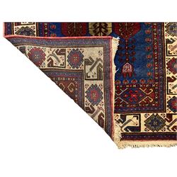 Turkish Yuruk indigo ground rug, the field decorated with geometric architectural designs, the guarded ivory border with repeating stylised plant motifs