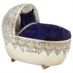 Victorian silver novelty pin cushion, in the form of a baby's crib, engraved with floral decoration, with blue velvet cushioned centre, hallmarked Horace Woodward & Co, Birmingham 1880, H4cm