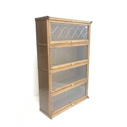 20th century oak library bookcase, four glazed up and over doors, plinth base