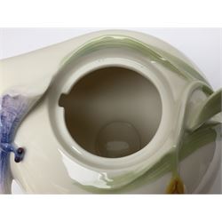 Franz Teapot decorated with dragonflies, together with a matching sucrier and cover and a cup and saucer in Iris pattern, all with printed mark beneath 