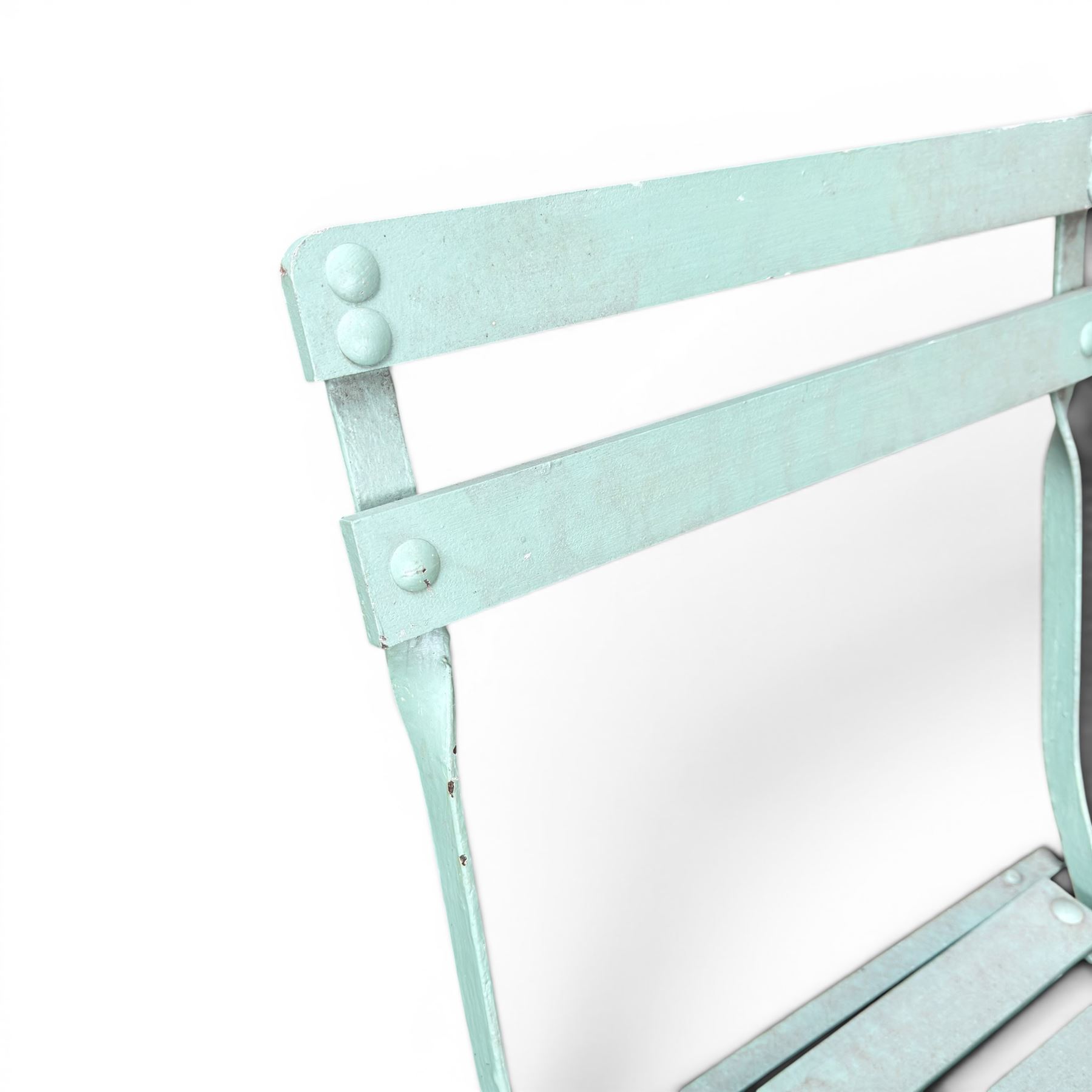 Wrought metal folding garden table, with painted wood plank top; and four matching folding chairs