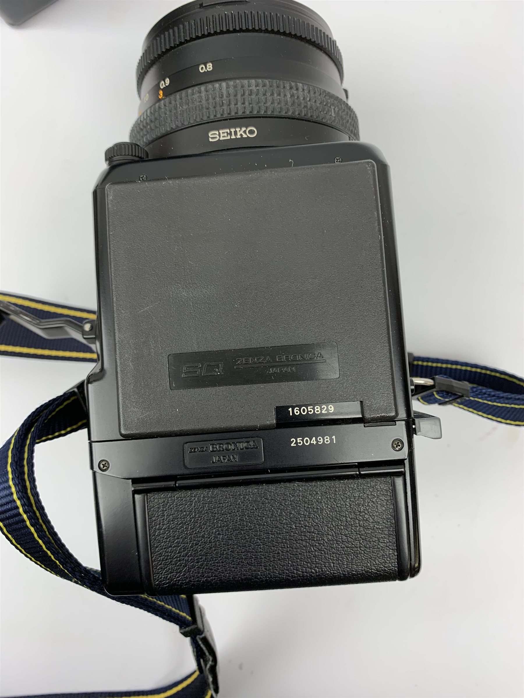 'Zenza Bronica SQ-B' camera fitted with 'Zenza Bronica Zenzanon-PS 1:28 f=80mm' lens, 'Zenza Bronica Zenzanon-PS 1:4 f=150mm' lens and 'Zenza Bronica Zenzanon-S 1:35 f=50mm' lens, with an instruction booklet