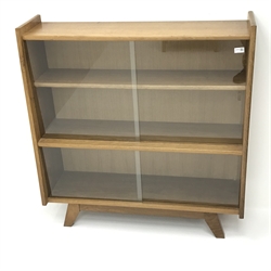  Light oak bookcase, sliding glass doors enclosing two shelves, W101cm, H108cm, D31cm  