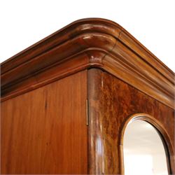 Victorian figured walnut double wardrobe, projecting moulded cornice over twin arched silvered mirrored doors, fitted with hanging rail and drawer with campaign style handle, on plinth base