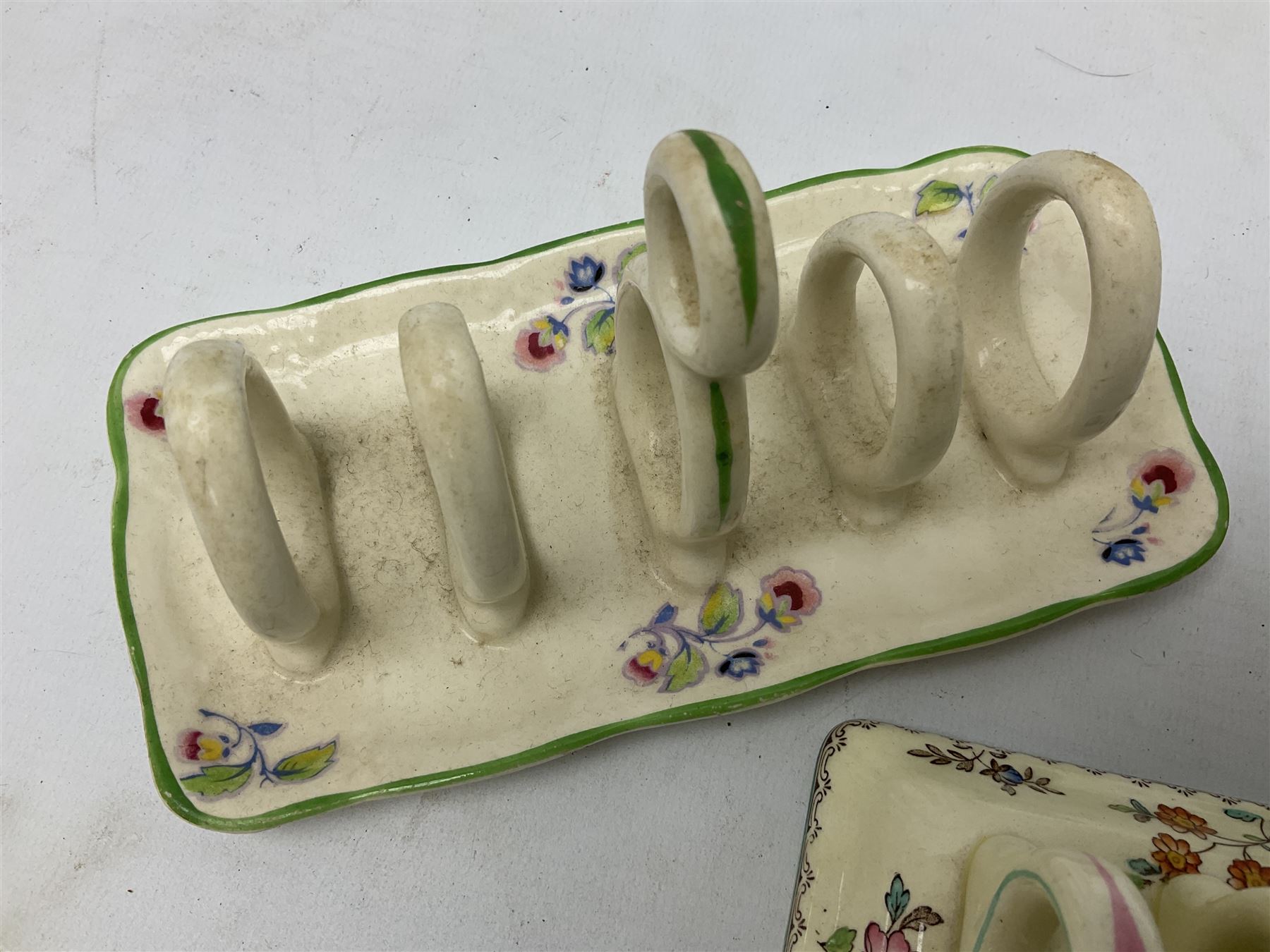 Collection of five toast racks comprising two Royal Winton Grimwades, Gray's Pottery, Copeland Spode Audley Royal Jasmine and another further early-mid 20th century toast rack decorated with flowers