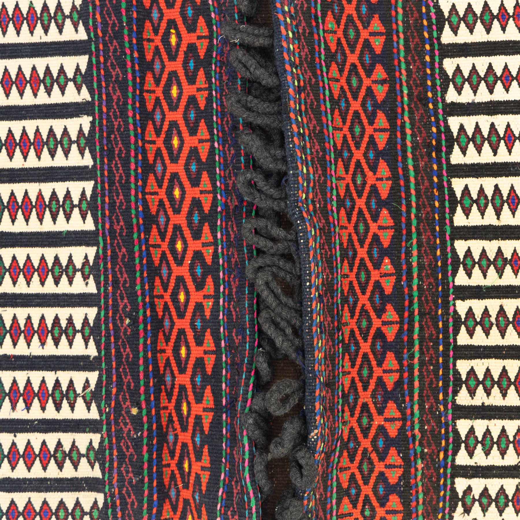 Persian Turkoman double saddlebag, north eastern region, with horizontal bands of multicoloured diamond motifs on a cream field, geometric border bands in red and black, joined with woven and wrapped centre panel