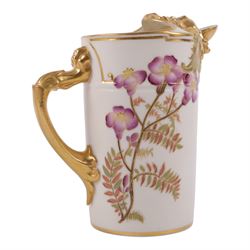 Three Royal Worcester jug in Blush Ivory, comprising squat winged dragon handled jug shape 1048, lion mask jug shape 1258 and Bacchus mask jug shape 1366, all with puce mark to base 