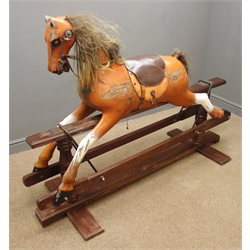  Carved wood and painted rocking horse on trestle base, L162cm  