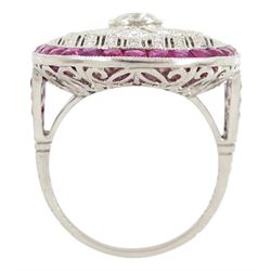 Platinum diamond and ruby oval cluster ring, principal transitional cut diamond of approx 0.55 carat, with milgrain set openwork diamond surround and calibre cut ruby border, with ruby and diamond shoulders