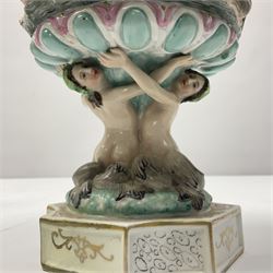 Early 20th century continental pedestal jar with cover, the bowl held aloft by four mermaids and decorated with putti playing instruments in a lake, the fluted domed cover topped with cherub playing a horn, H38cm