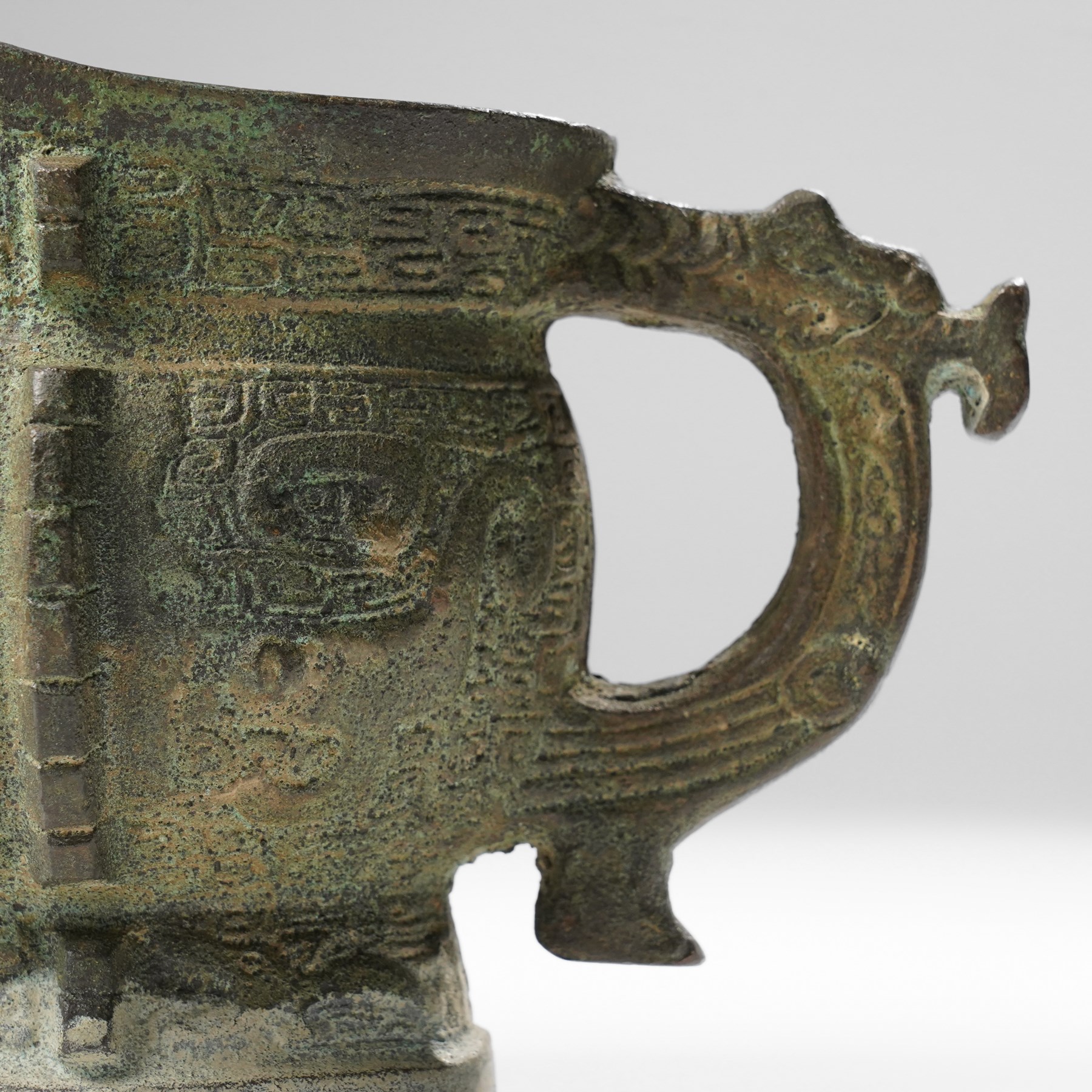Chinese archaistic bronze wine vessel, Shang dynasty style but 20th century, W25cm; together with a Tang dynasty style model of a rearing horse, H17.5cm (2)