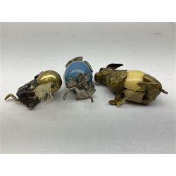 Edwardian gilt metal and Ivorine Rabbit tape measure, together two other tape measures in the form of an owl and in the form of a cat its front paws resting on a ball, owl H5.5cm