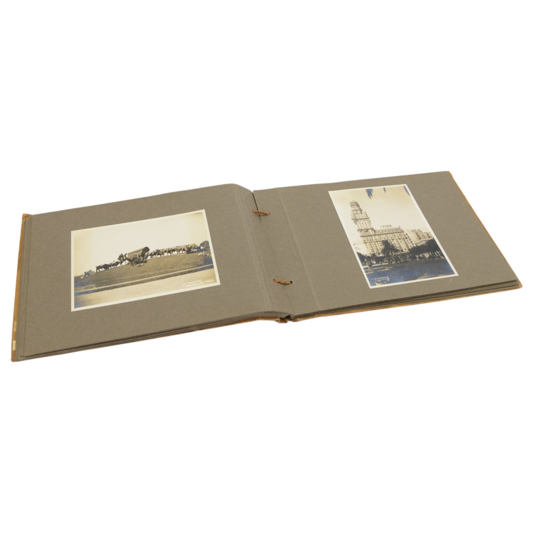 Early 20th century photograph album, documenting the travels of RMS Alcantara, with painting to front cover and containing black and white photographs