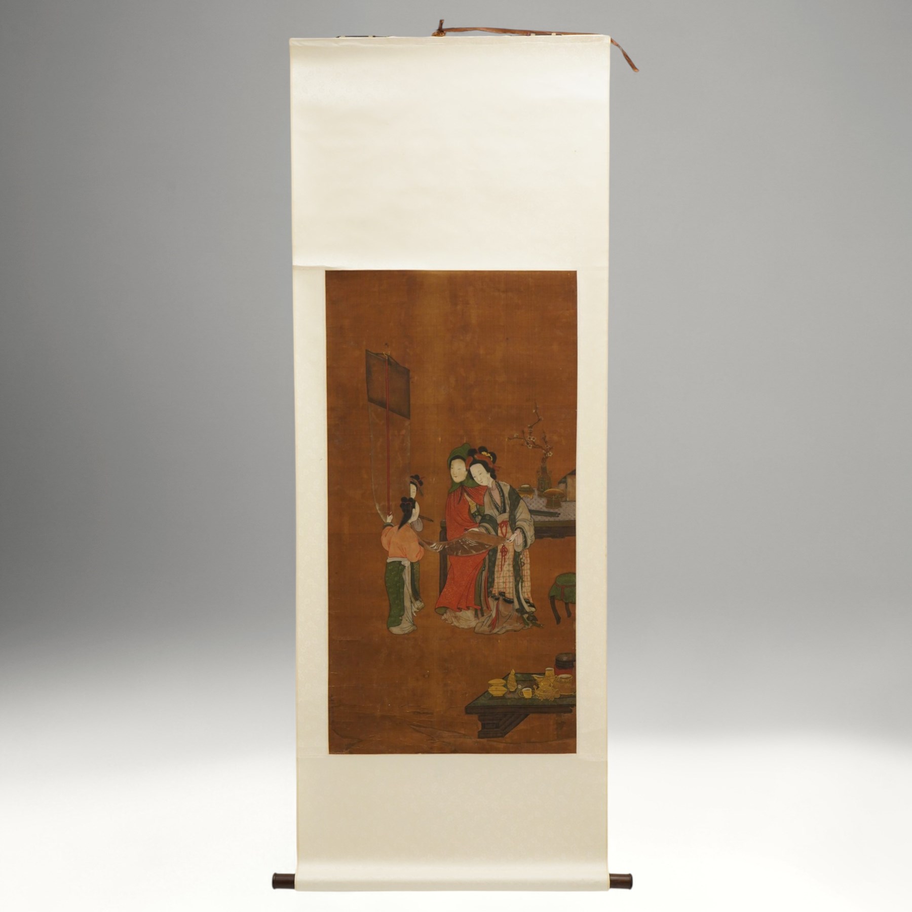 After Li Gonglin (Chinese 1049-1106): Court Ladies Examining a Scroll, 19th century hanging scroll, ink and pigments on silk with light brocade margins, bearing inscription, image size 101cm x 52cm 