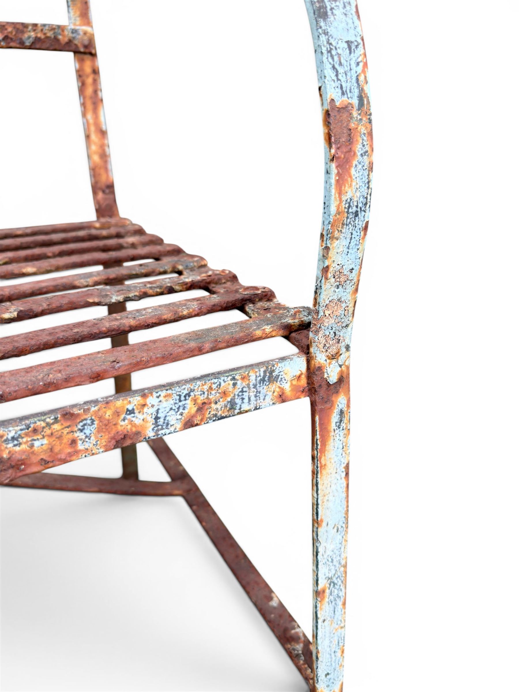 Regency period wrought iron strapwork garden bench, cresting rail with central Scottish thistle motif and flanking pediments, in distressed blue painted finish