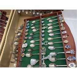 Six wooden spoon racks, containing a large quantity of silver plated souvenir and other collectors spoons