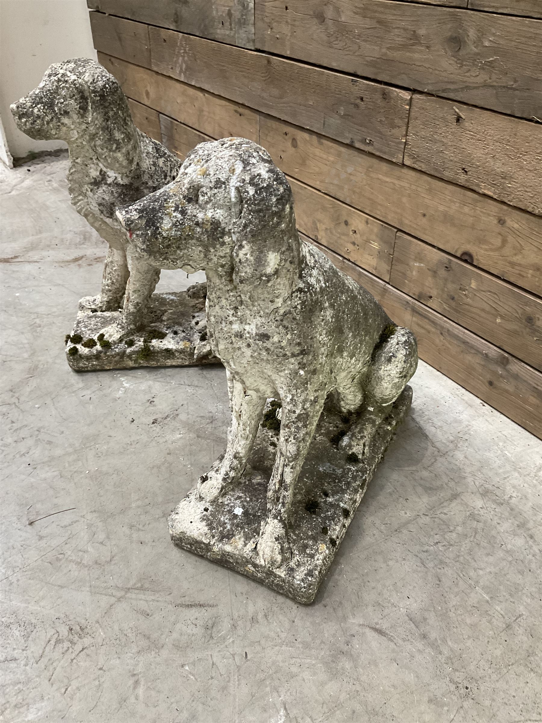 Pair of cast stone garden dogs and 2 female figures,