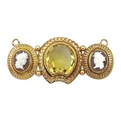 Victorian 15ct gold mounted citrine and cameo pendant, the central horseshoe shaped citrine with laurel leaf surround flanked by two Classical figure cameo's