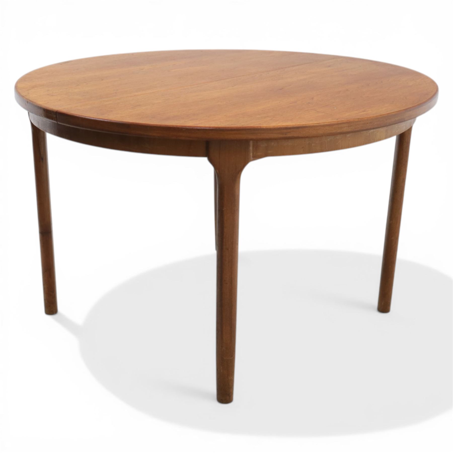 A H McIntosh & Co of Kirkcaldy - teak circular top with moulded edge enclosing butterfly leaf extension, raised on four tapering supports, extending action revealing central leaf, 167cm fully extended