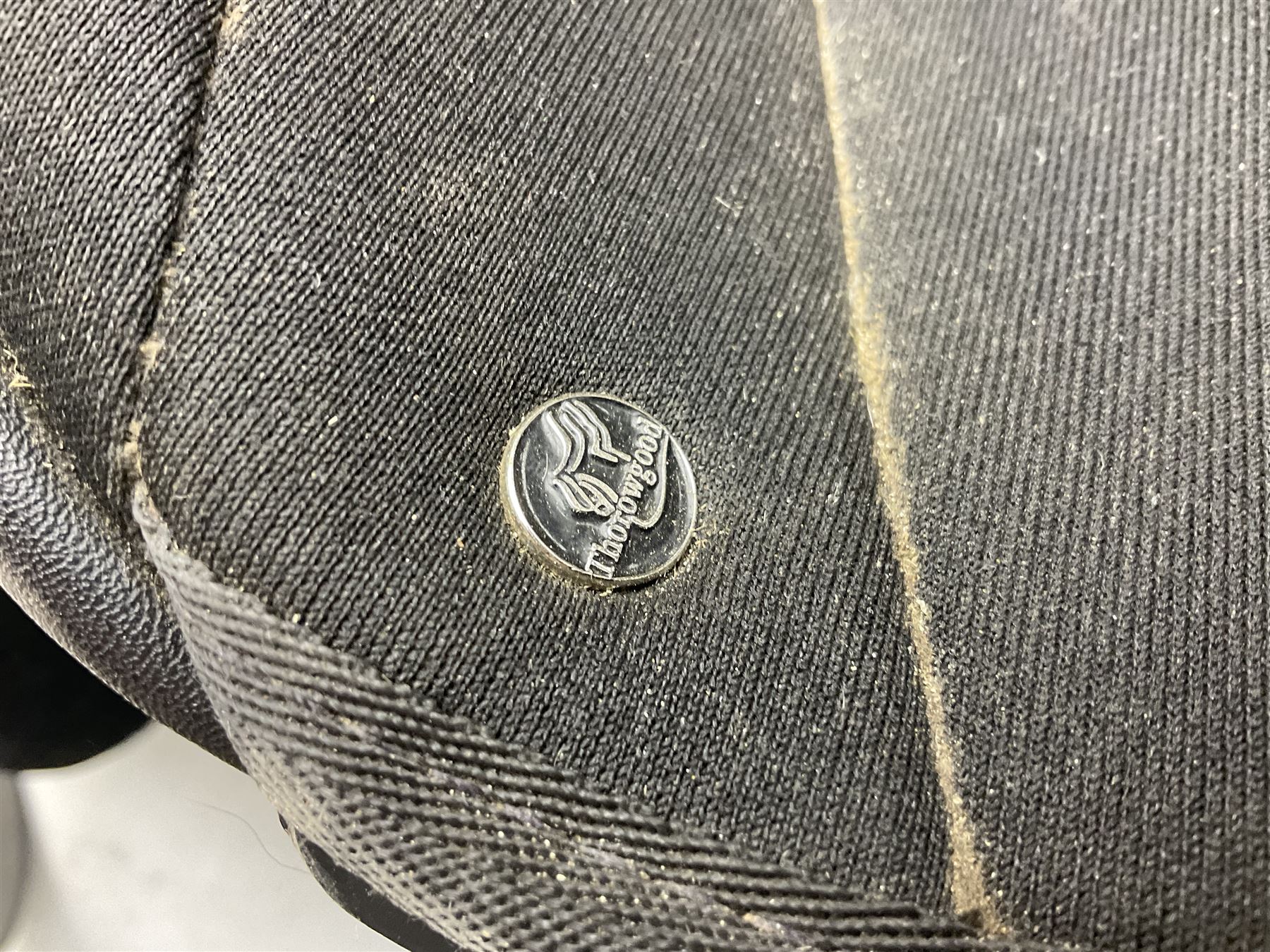 Collection of nine saddles, mainly havana leather to include a racing saddle and a Goodwin saddle, some with stirrups and leathers 