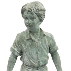 After Eneri Prosperi, bronze garden child statues, depicting children balancing on rock-form bases, the boy in shirt and shorts, the girl in dress with raised arms, surrounded by loose rounded pebble elements