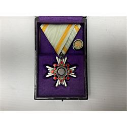 Two Japanese silver medals - Order of the Golden Kite 7th Class; and Order of the Sacred Treasure 6th Class with pin badge; each in a lacquered box with characters to the lid (2)