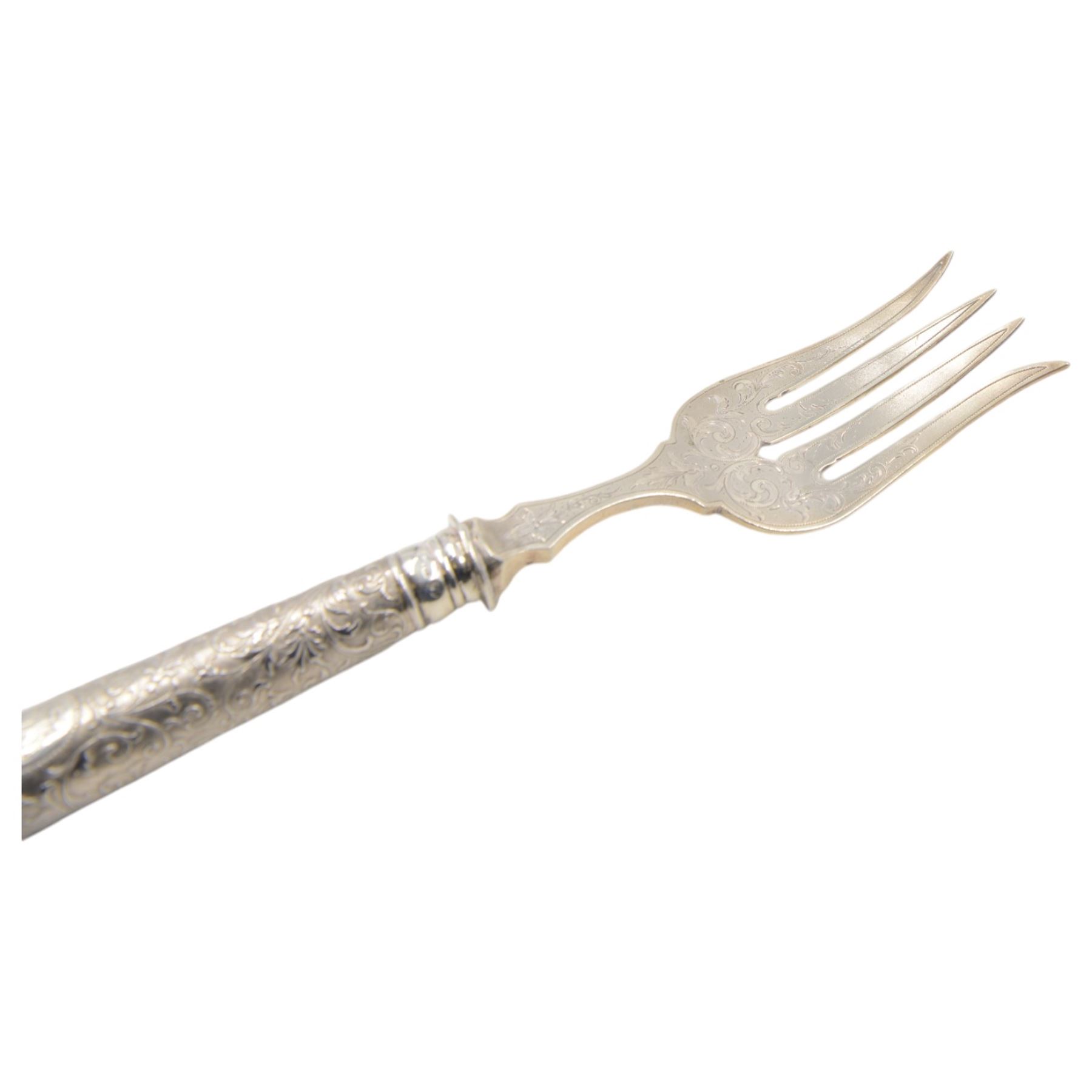 German silver handled four pronged fish serving fork, the tapering cylindrical handle with chased and repousse foliate decoration, engraved with monogram, stamped 800 with crescent and crown mark, L28cm

Notes: By vendor repute belonged to 7th Baron Brownlow 