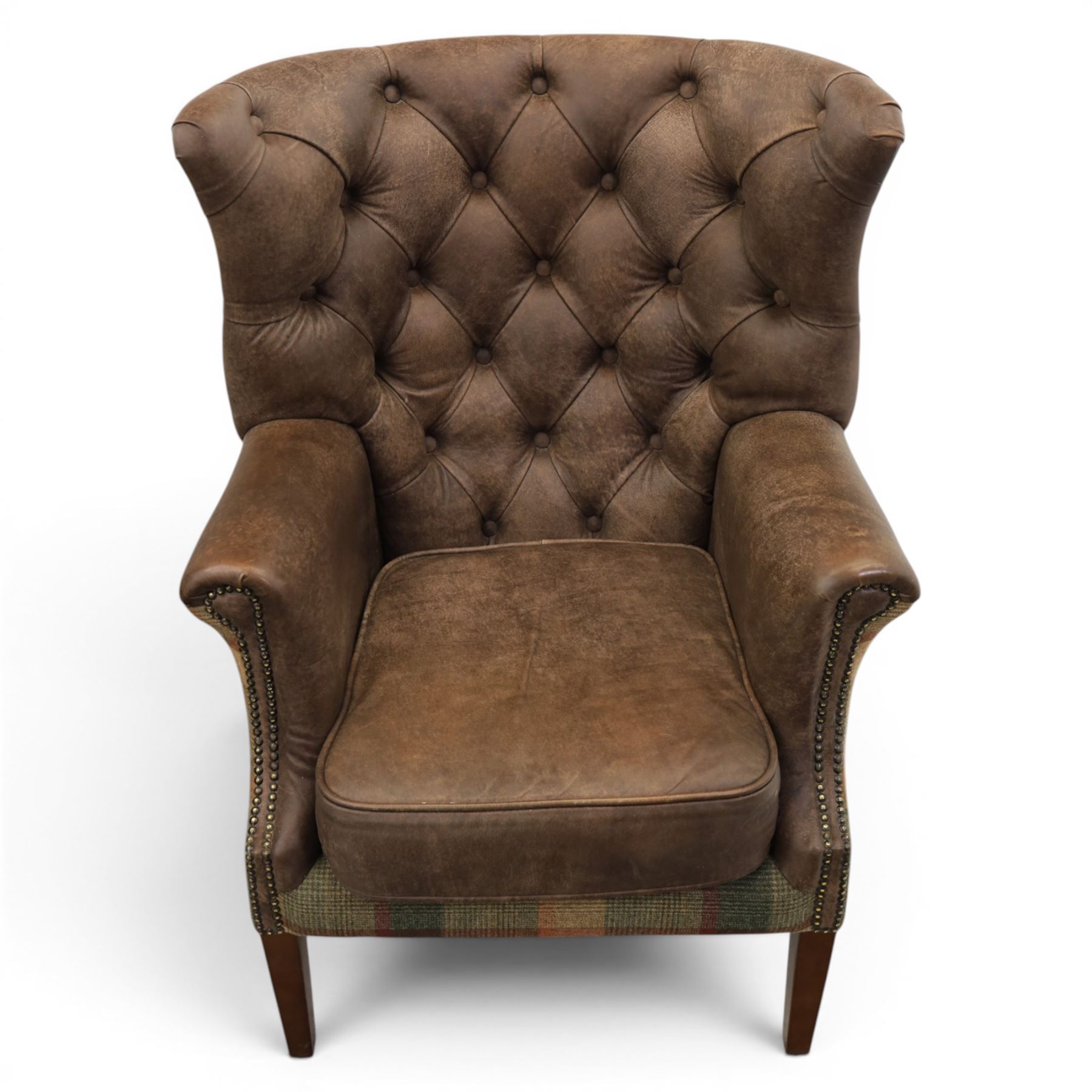 Pair of Georgian design wingback armchairs upholstered in brown leather and tartan tweed fabric, button back and scrolled arms with brass studded trim, square tapered supports