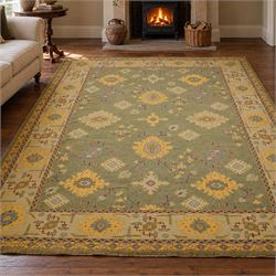 Lage Turkish Oushak green ground carpet, the field decorated with large stylised plant mot...