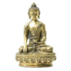 Late 19th/early 20th century brass Buddha in lotus position holding a 'singing' bowl H21cm