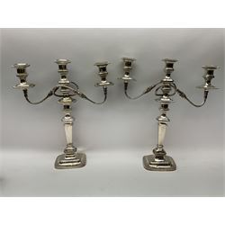 Pair of silver plated three branch candelabra, with urn shaped nozzles on reeded scrolling branches, on a knopped and tapering stem, raised on a regular foot, together with a trefoil wine holder with vine leaf and grape detail, and other silver plate and metal ware, candelabra H47.5cm 