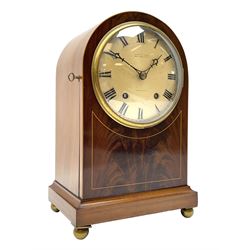Winterhalder and Hofmeier eight-day striking mantle clock retailed by John Walker, South Molton Street, London “TO HM THE KING”, c 1905, In a round topped figured mahogany veneered case with inlaid satinwood stringing, on a concave moulded plinth raised on four bun feet, with a silvered dial, short Roman numerals, minute track and matching pierced steel hands within a brass bezel and convex glass, going barrel movement with a recoil anchor escapement striking the hours and half hours on a coiled gong.



