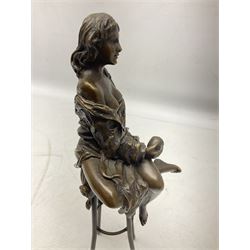 Art Deco style bronze modelled as a female figure seated upon a chair holding an apple, after 'Pierre Collinet', H28cm