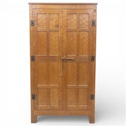 Acornman - oak adzed panelled double wardrobe, with wrought iron hinges and carved oak latch revealing a single clothes rail, with signature carved acorn to top right, by the workshop of Alan Grainger, Brandsby