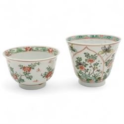 Three Chinese famille verte examples, approximately Yongzheng period, to include two teabowls and two saucers, each decorated with flowers and butterflies, two with sacred fungus mark within double rings, the teabowl with lotus mark, the other indistinct - possibly a Wan mark within lozenge (4)