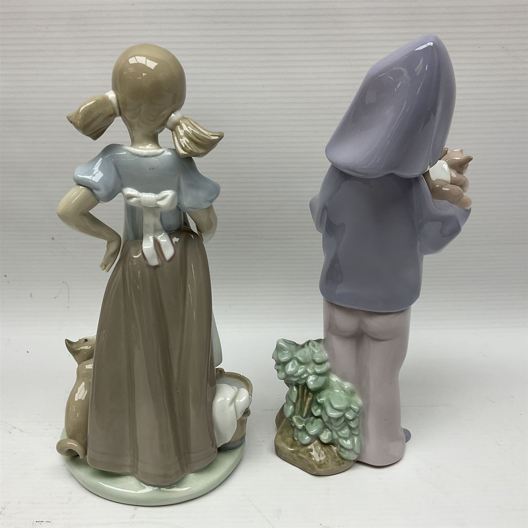 Five Lladro figures, including The Lamp Lighter no 5205,  Girl and Kittens no 6102, Cat no 5113 etc