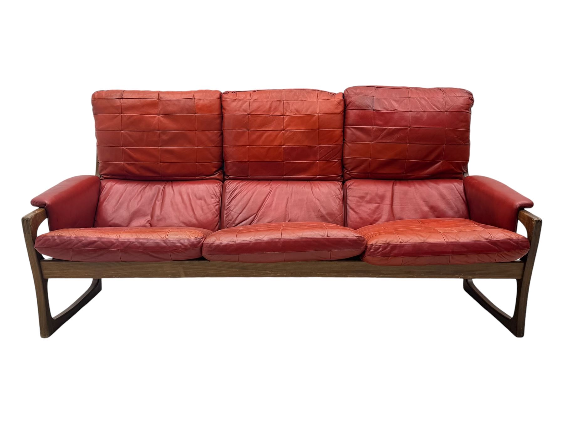 Folke Ohlsson for Gimson & Slater - mid-20th century Danish teak-framed sofa, red leather upholstery with patchwork design, raised on shaped teak side supports