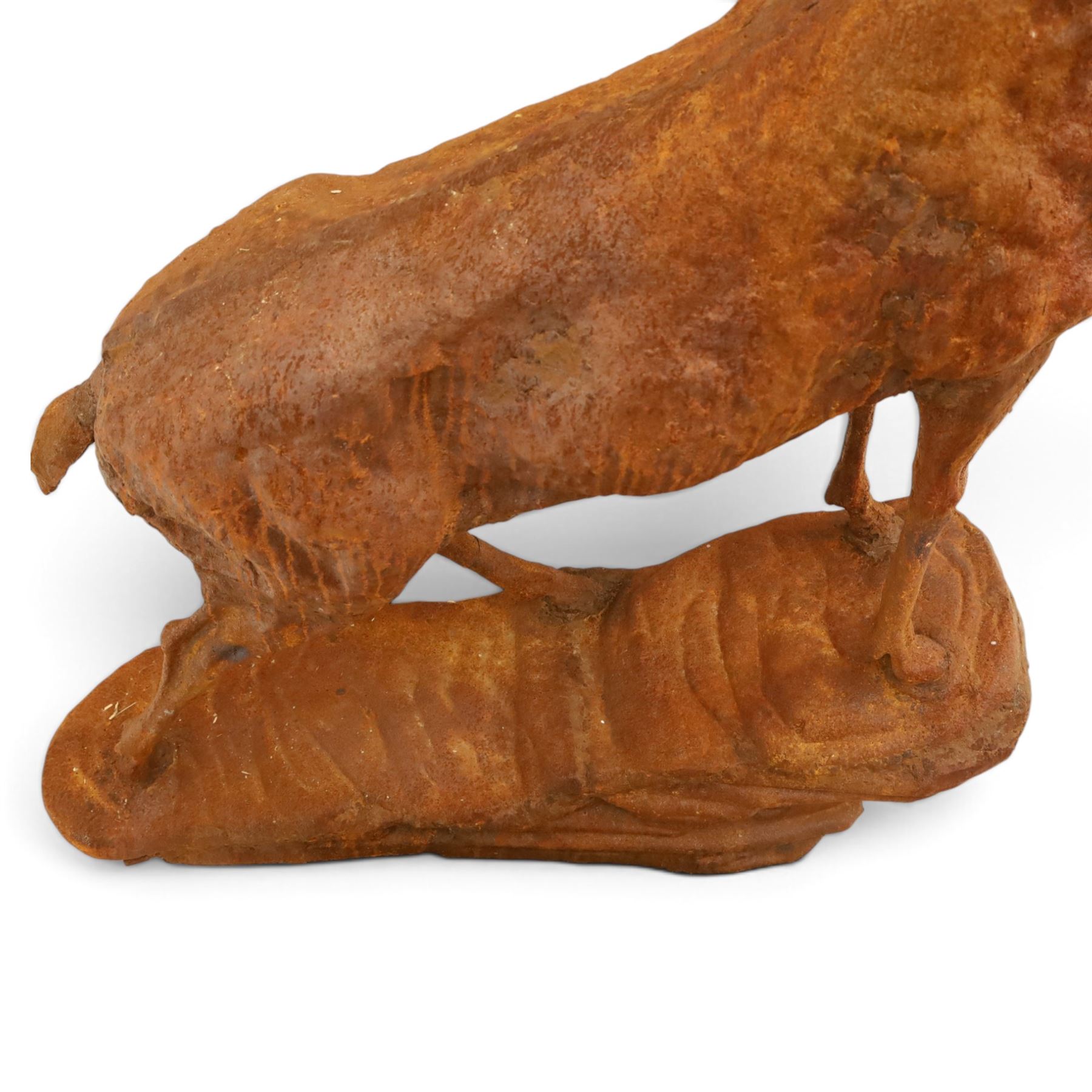 Pair of cast iron stags, upon a on moulded rocky plinth, standing alert 