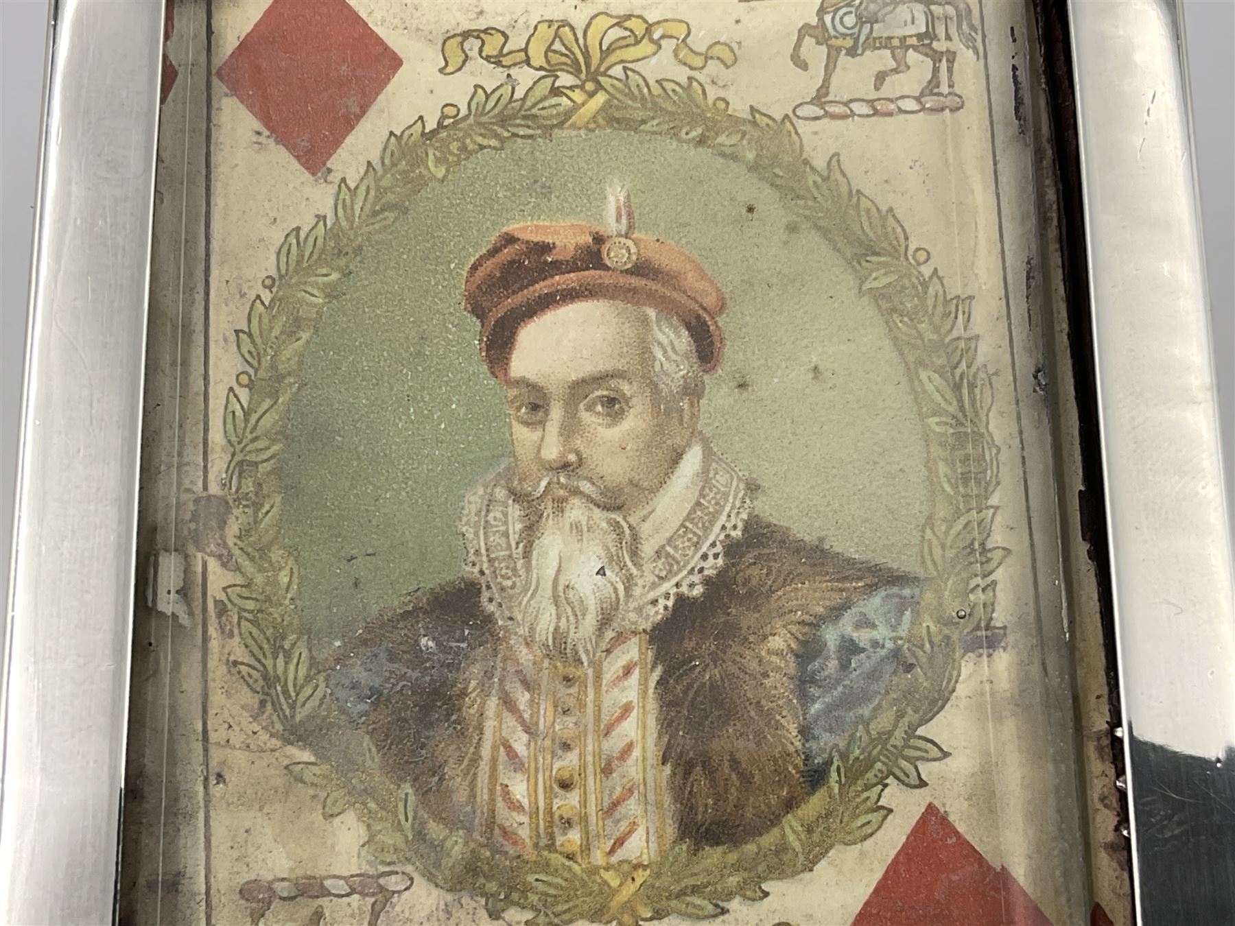 Edwardian silver mounted playing card case, hallmarked William Harrison Walter, Birmingham 1903, the sides each with a period playing card set behind a bevelled glass panel, the hinged cover with later engraving 'Presented to Norman T Crombie Esq by the officers & men of the 31st WR Detachment for services rendered 1917-1918', with red leather lined interior, the three compartments upon a sprung base and containing two later wooden Whist markers, case H12.5cm