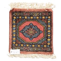 Long flatweave Kilim textile cushion, in crimson and decorated with geometric motifs and cotton fringe ends, 151cm, together with four modern hand-knotted rug mats with geometric designs, the largest 65x43cm, (5)