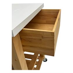 Contemporary butchers block kitchen trolley, white square top over beech frame, single pull-out drawer, dual slatted shelves, chrome towel rails, raised on square supports with castors