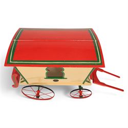 G & J Lines wooden gypsy caravan model, painted in cream with red roof, wheels and green detailing, H51cm, L89cm