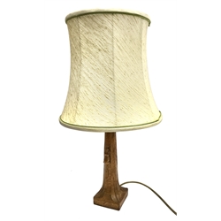 'Mouseman' oak table lamp, tapered octagonal form on carved square base, by Robert Thompson of Kilburn, H30cm (measurement excluding fitting and shade)