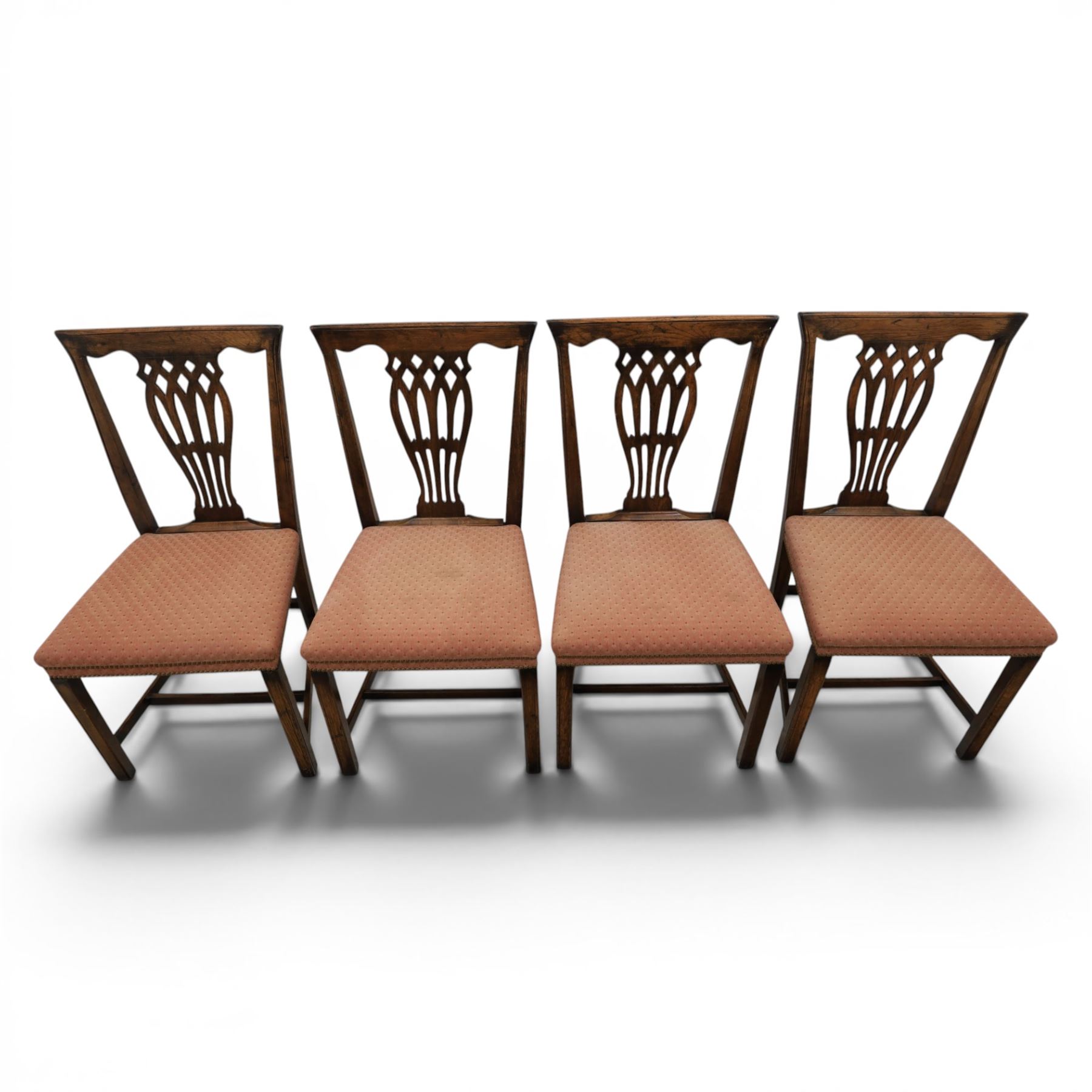 Set of eight George III dining chairs with padded seats, pierced vasiform splat, upholstered seat with brass trim, on square supports with H-stretcher